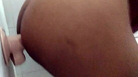 Amateurs experiment with dildo in the bathroom setting.