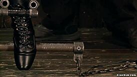 Blonde bound in extreme back arch stock setup for kinky play.