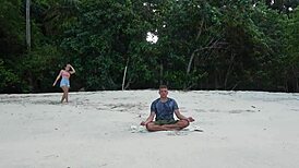 Girl gives sloppy blowjob on beach during meditation.
