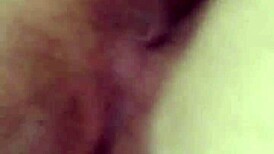 Tanned latina flaunting her natural tits and juicy pussy in a lively display.