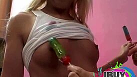 two babes licking popsicles during natural tits photoshoot, leading to orgasm