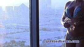 Busty milf charity mclain oils her bikini body and masturbates with glass dildo