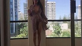 this ladyboy dances on the balcony with big tits