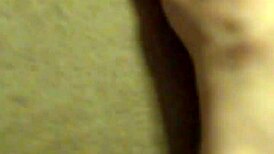 A redhead woman showcases her ginger-colored breasts in a natural setting.