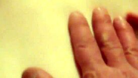 A redhead woman showcases her ginger-colored breasts in a natural setting.