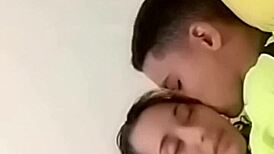 sexy couple lounging in bed sharing laughs and cuddles with soft music playing in the background