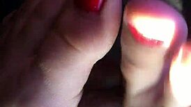 My friend gives an amazing footjob in the car, leading to cum