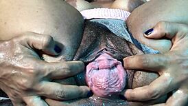 A juicy pussy drips with wetness in close-up view