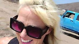 Nude milf boldly exposed in public outdoor setting.