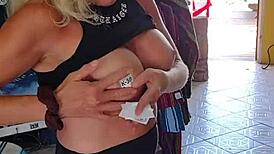 Nude milf boldly exposed in public outdoor setting.