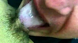 Mature woman receives oral attention in a subtle intimate setting.