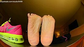 Tall girl shows sexy barefoot feet in Nike shoes for foot fetish domination
