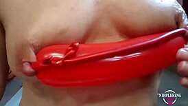 Extreme nipple stretching with balloon piercing.