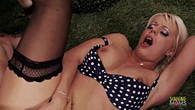A tall blonde milf with large breasts is pleasured with her hand until she is filled with a well endowned man on her backside