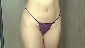 Brunette in red lingerie performs striptease, ripping clothes to show ass and natural tits from pov