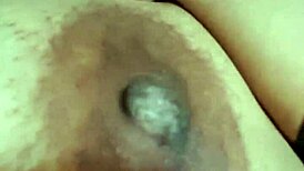 The ebony beauty with green eyes showcases her big tits in a captivating display.