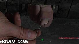 extreme sadomasochism with intense bondage and pain play in dark dungeon