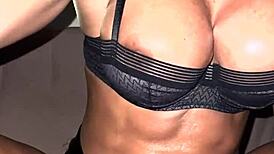 Busty muscle girl lights up a cigarette with fierce athletic charm.