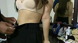 Beautiful Thai girl poses in mirror