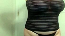 Sheila, the busty milf wife, rips her clothes off in a seductive striptease, revealing her big tits while undressing slowly.