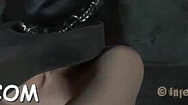 This clamped hottie takes a hook in her anal with a toy.