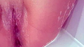 that milf bitch masturbating her shaved pussy in the bath, so steamy! 😍