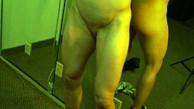 busty ginger shows off muscles in mirror