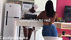 Naughty wife teases husband in kitchen while friend chats