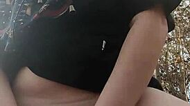 Woman gets fucked with dildo in the forest, moaning loudly.