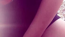 Woman gets fucked with dildo in the forest, moaning loudly.