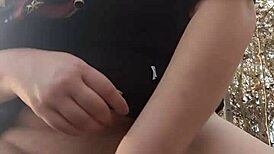 Woman gets fucked with dildo in the forest, moaning loudly.