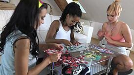 Three amateurs tease with long legs while doing puzzle