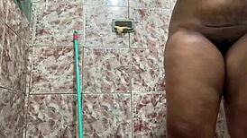 Morena with big tits showing off in the shower.