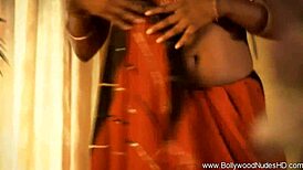 She's teasing and dancing nude, stripping sensually