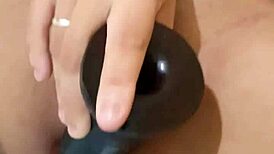 Milf enjoys solo masturbation with black dildo