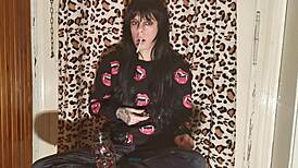 smoking goth girl relaxes behind the scene after a long day?