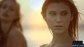 Four lesbian girlfriends strip and play with each other on a sunny beach.