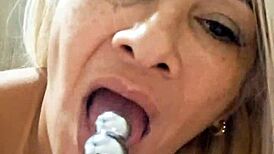 Naked milf plays with dildo in her pussy.