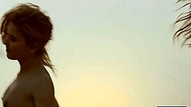 Four lesbian girlfriends strip and play with each other on a sunny beach.