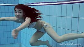 Roxalana Cheh feels the thrill as sexy redhead underwater with tight shaved ass