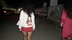 Two Girlfriends Pee Together by Car in Public Parking Lot