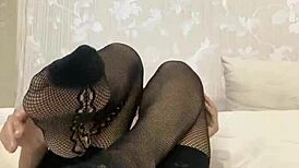 She teases with a dildo footjob in black nylons