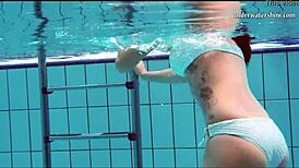 Teen brunette's hot tits and shaved pussy underwater.