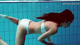 Teen brunette's hot tits and shaved pussy underwater.