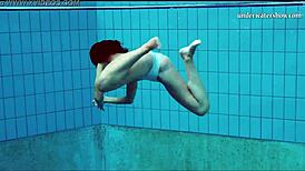 Teen brunette's hot tits and shaved pussy underwater.