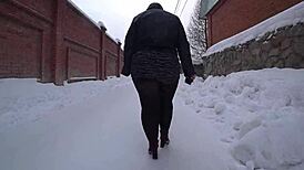 Yo, check this curvy milf's big ass in pantyhose on a snowy street!