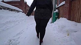 Yo, check this curvy milf's big ass in pantyhose on a snowy street!