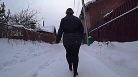 Yo, check this curvy milf's big ass in pantyhose on a snowy street!