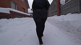 Yo, check this curvy milf's big ass in pantyhose on a snowy street!