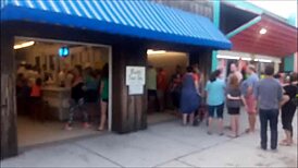 Beautiful women in bikinis at the beach in a photo shoot.